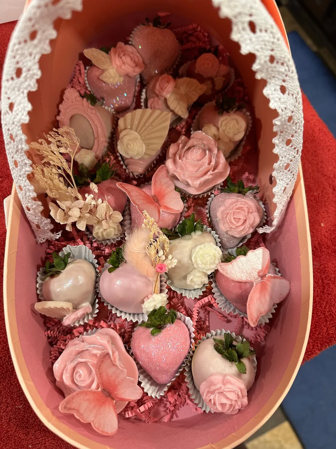 Inside the carriage: pink strawberries with chocolate roses and butterflies